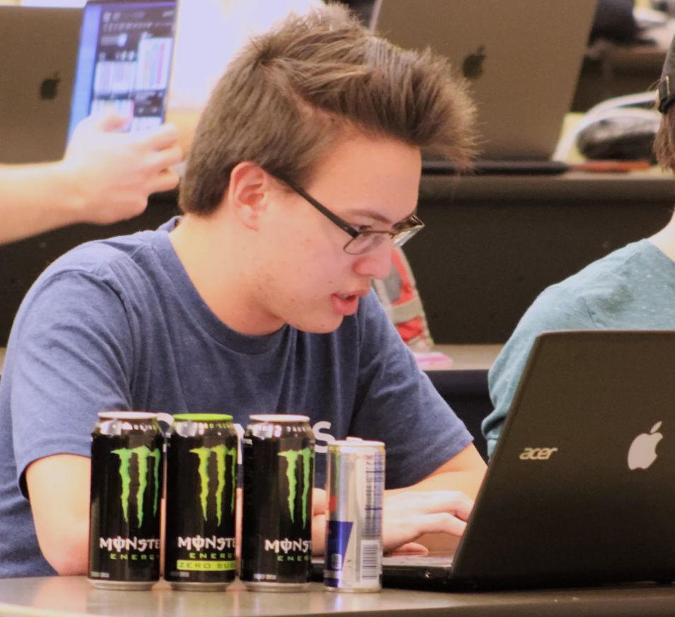 I code on my laptop behind a row of 3 Monsters and a Red Bull.