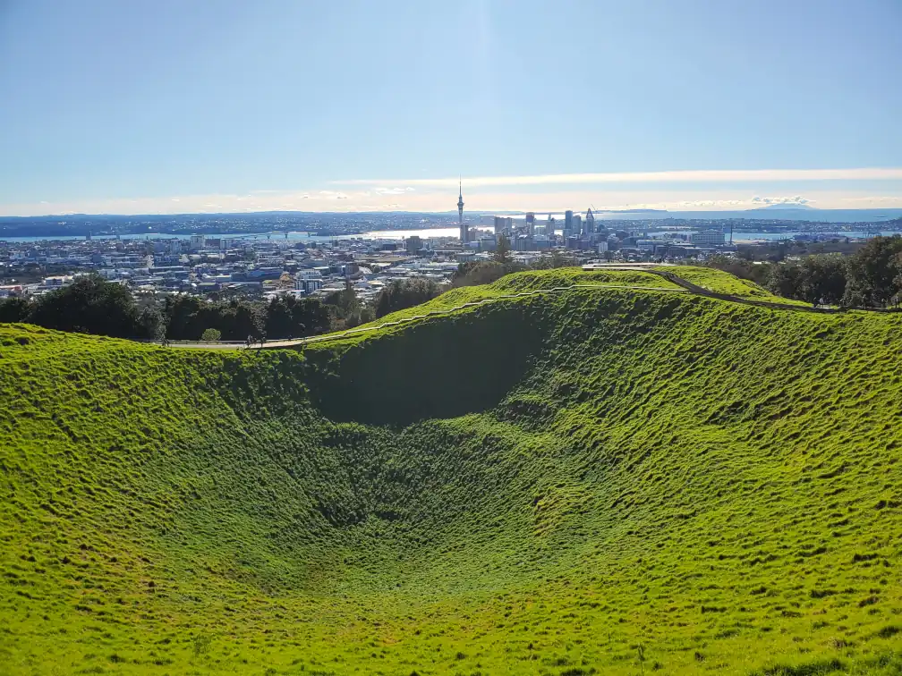 The crater of Mount Eden in the foreground and the Auckland skyline in the background